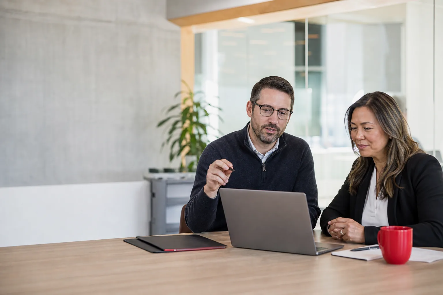 An IT specialist and business leader reviewing a practical support plan together